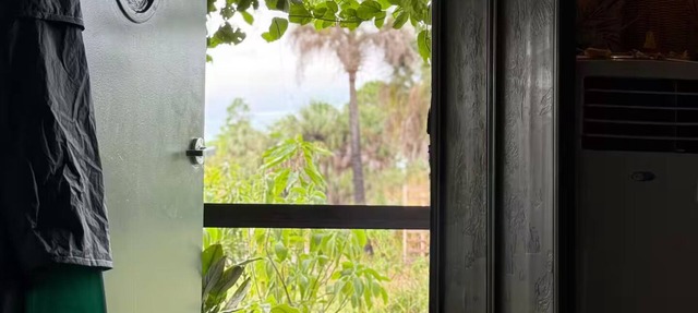 Luxury off-grid passionfruit covered shipping container immersed in nature. in Naples