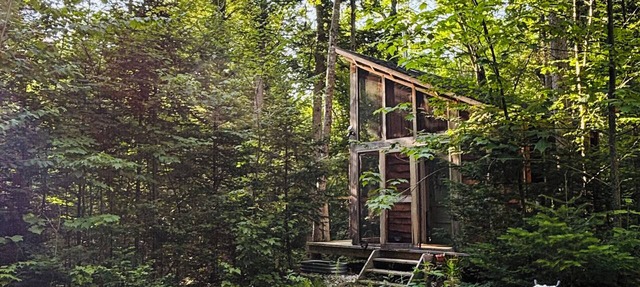Rustic creek side cabin in the woods in Granville
